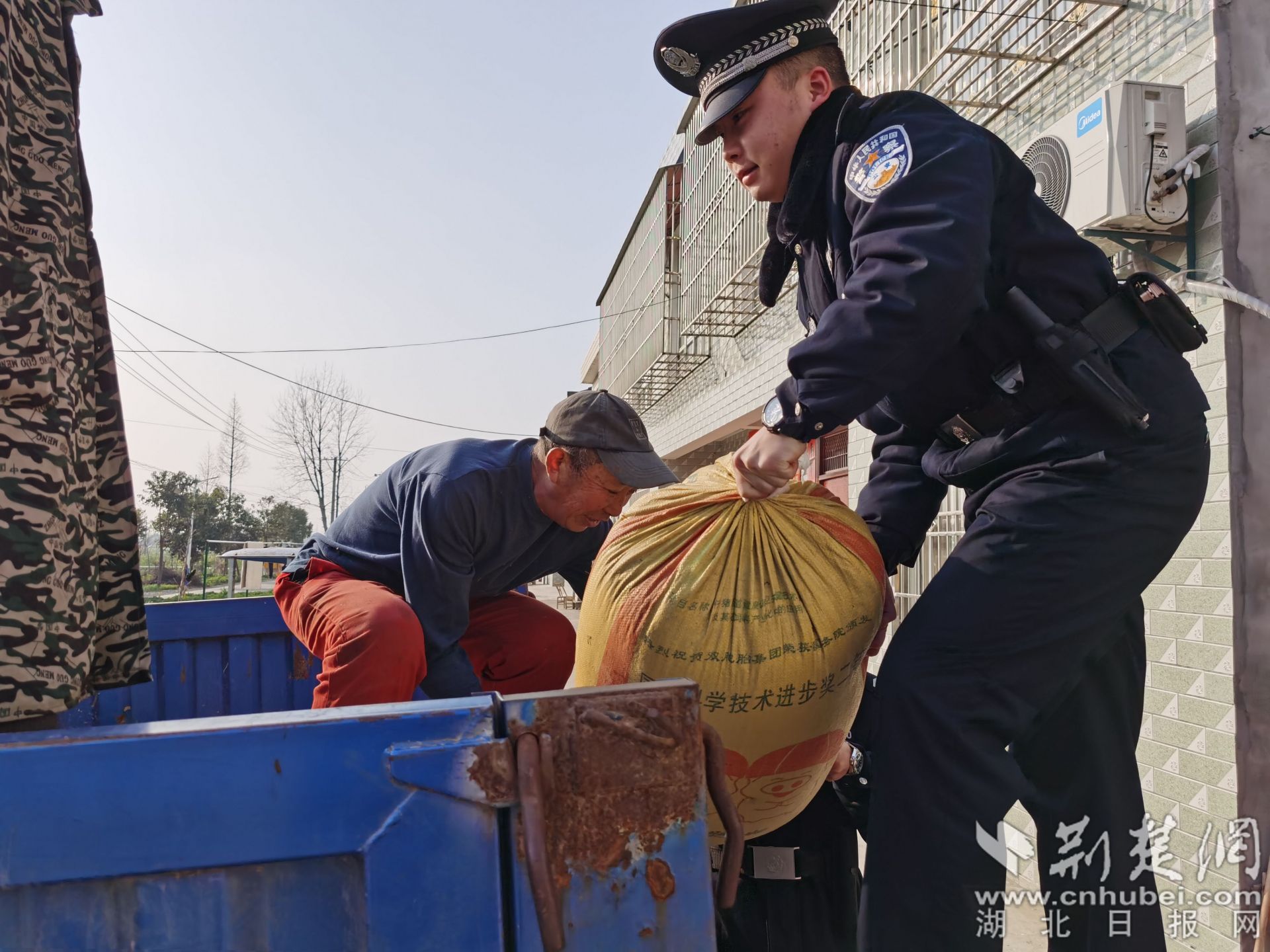 民警利用走訪間隙幫助農民群眾干農活.jpg.jpg